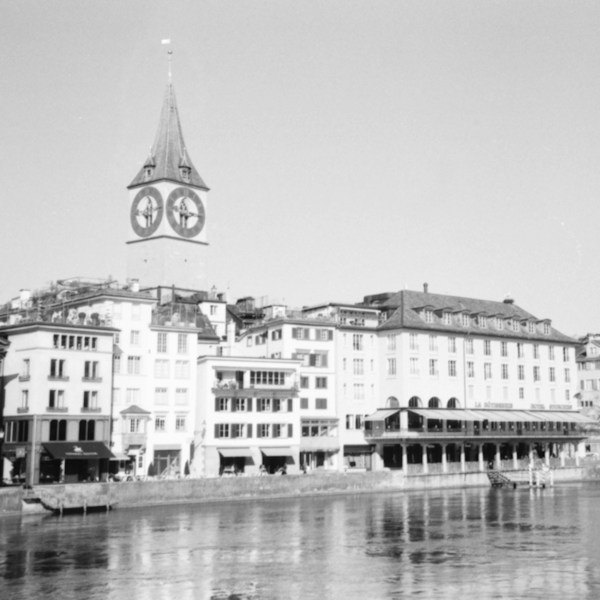 Black and white view of St. Peter's church and riverside houses along the Limmat